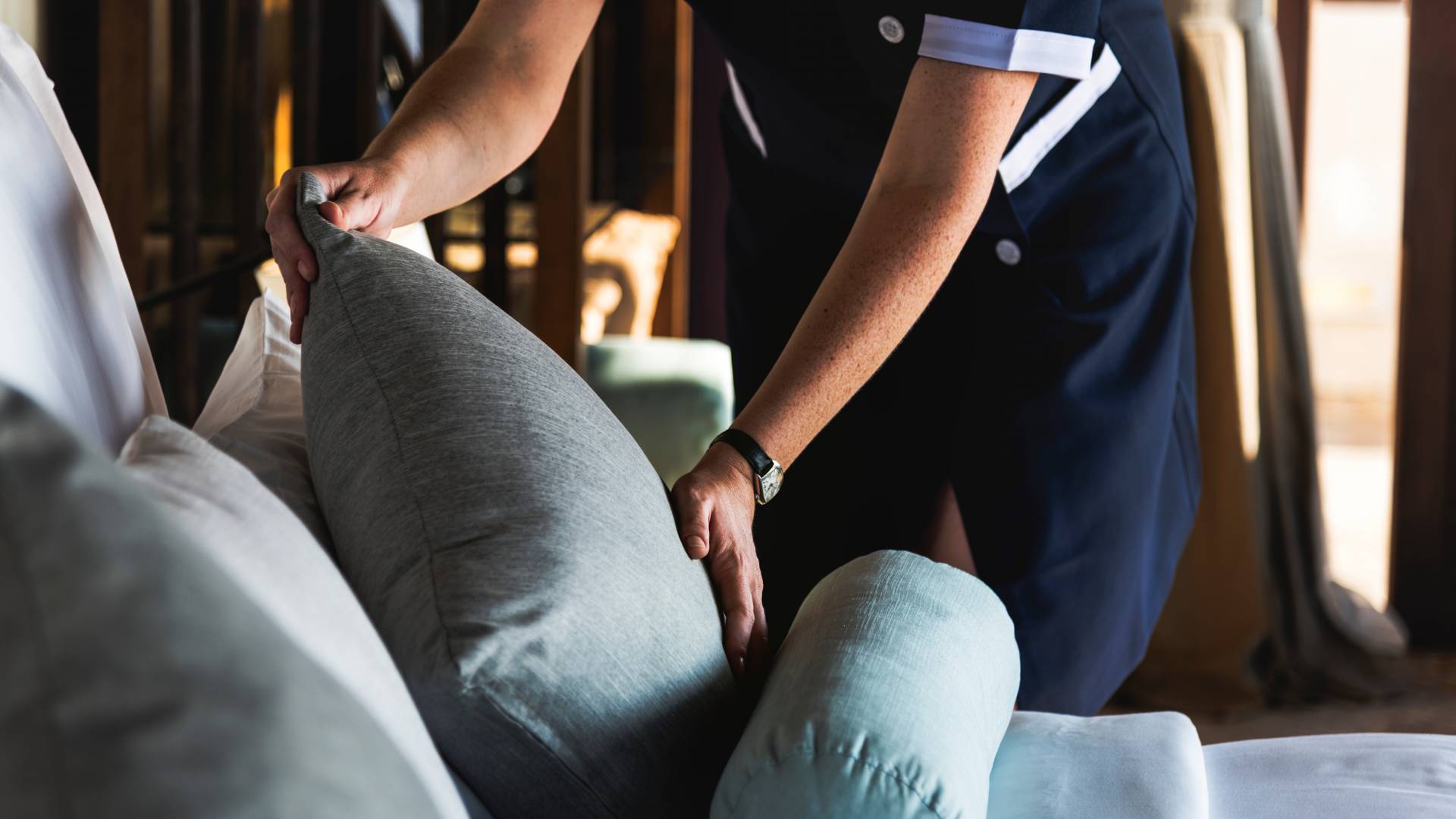 Housekeeper cleaning a hotel room